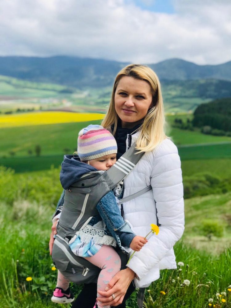 woman with a sleeping child in the nature