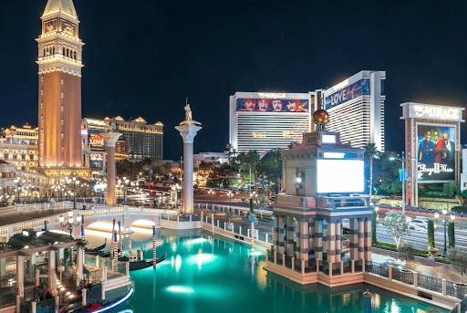 Bright nighttime view of Las Vegas Strip with iconic landmarks and vibrant city lights.